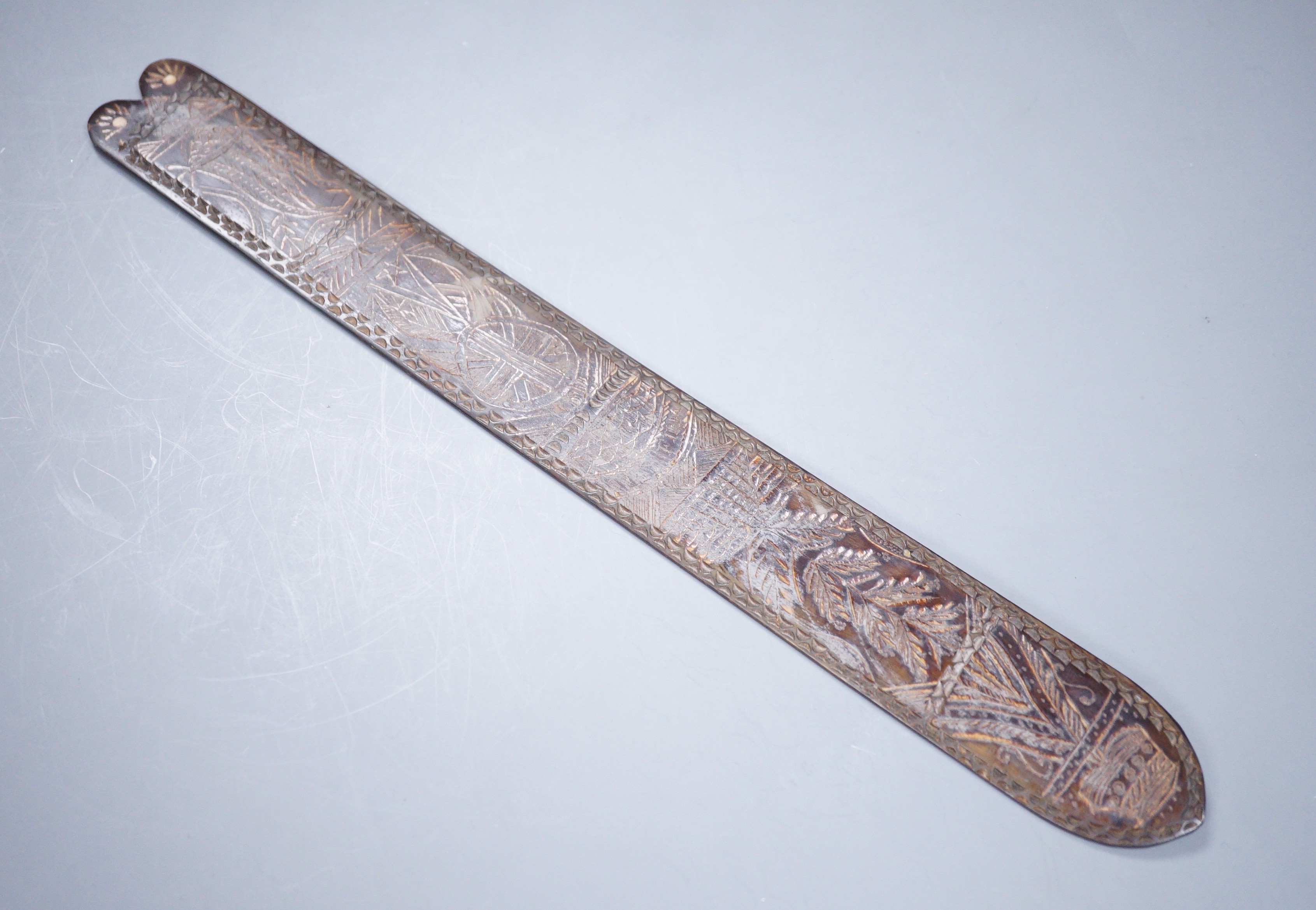 A 19th century carved horn page turner with bone inset roundels, 30.5cm